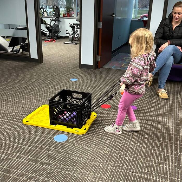 A young child engaged in a play-based pediatric therapy session at Move To Success.
